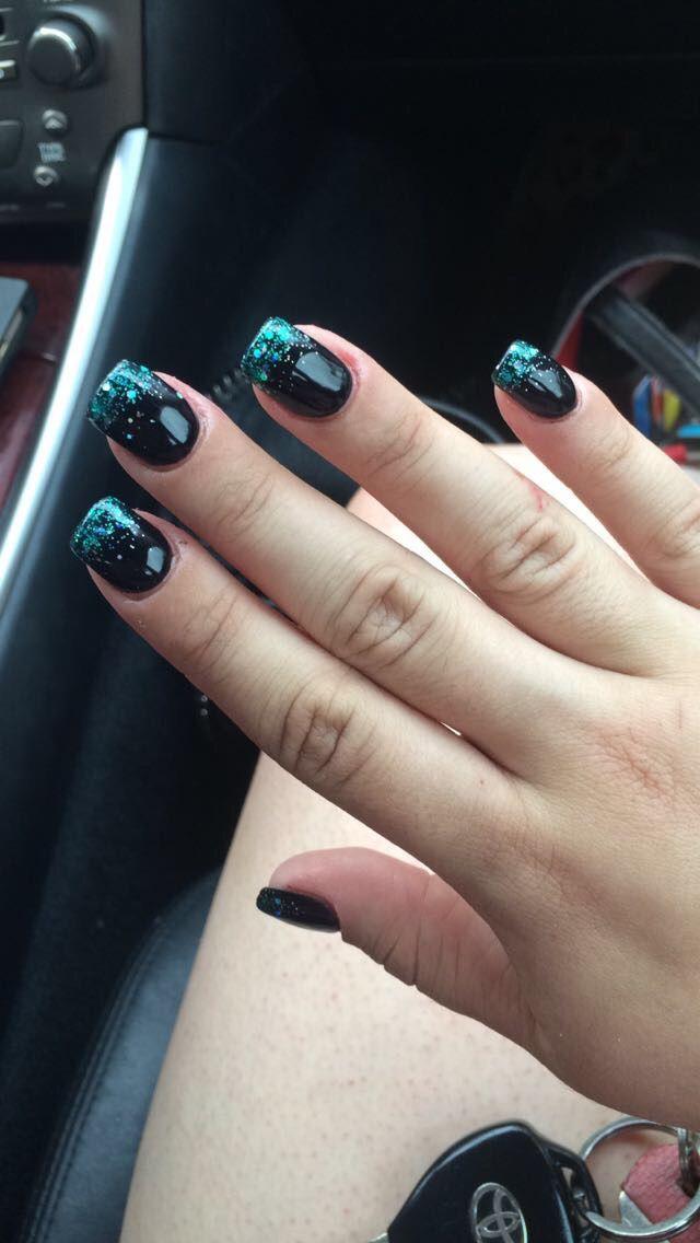 Black nail polish with gold glitter cascading tips.