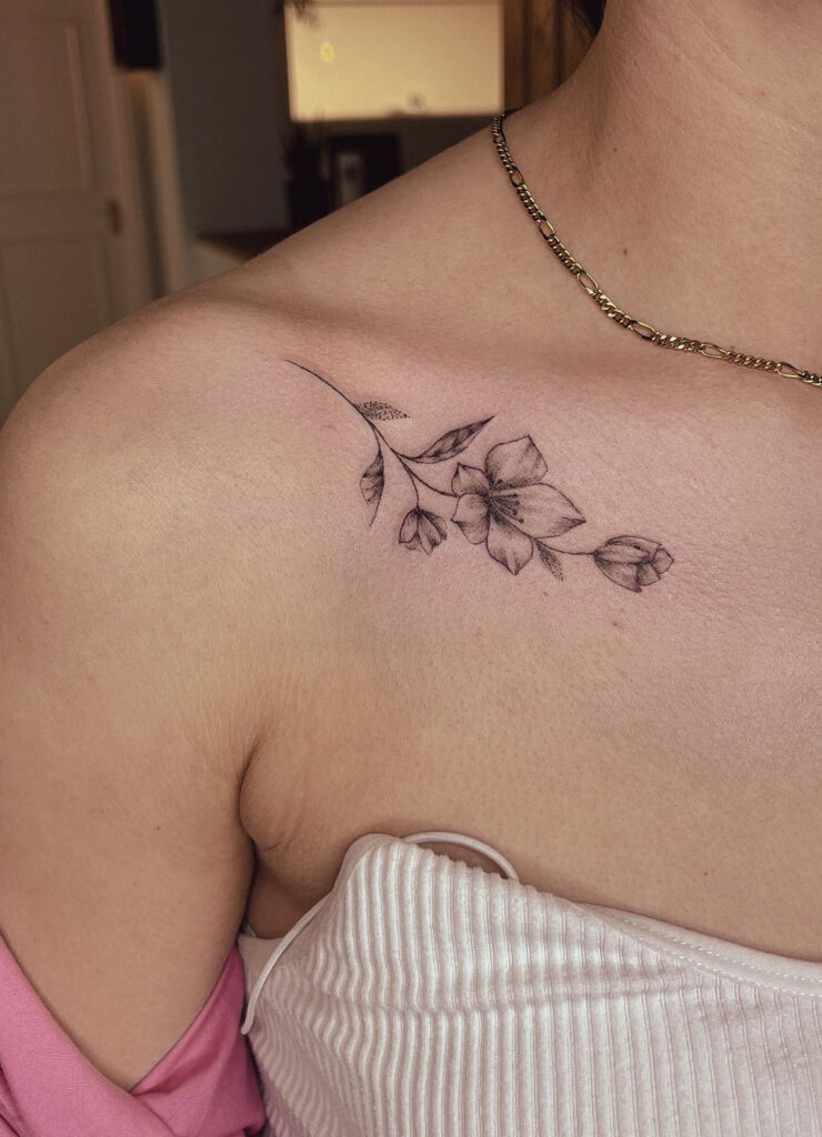 Blooming flowers collarbone tattoo