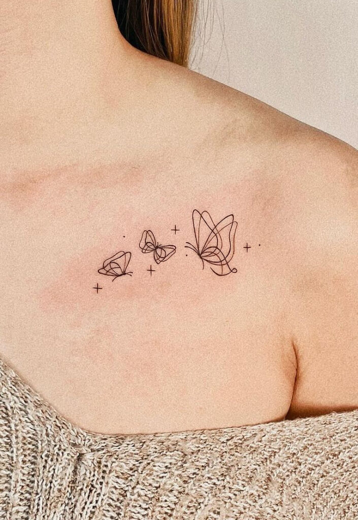 Illustrated butterflies collarbone tattoo