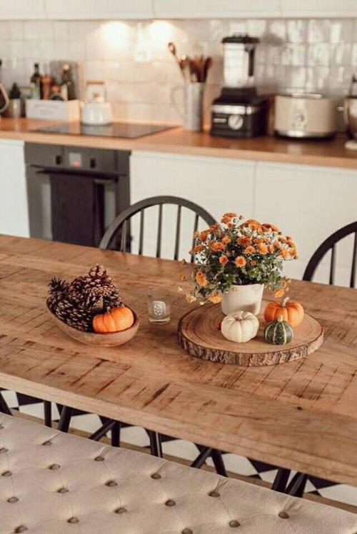 Fall flowers, pumpkins, and pinecones